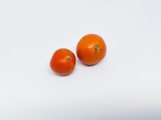Two ripe tomatoes isolated on a clean white background. Perfect for illustrating healthy eating, fresh produce, and culinary themes. Ideal for food-related projects.
