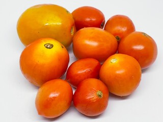 A collection of vibrant, ripe tomatoes, perfect for cooking, salads, or a healthy snack. These fresh fruits offer a burst of flavor and essential nutrients.