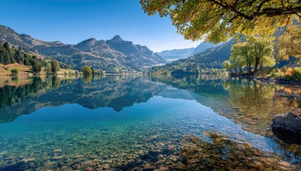 Calm autumn lake reflecting mountains; sunny day