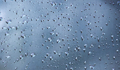 Close Up Shot of Raindrops on Window Highlighting Texture and Transparency of Water Droplets