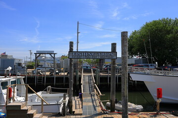 Fishing trips sign in the marina of a harbor town in New England, USA