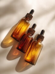 Naklejka premium Elegant Skincare Product Mockup: Trio of Amber Dropper Bottles on White Background