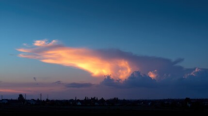 Fototapeta premium Cat-shaped cloud glowing softly with the colors of sunset