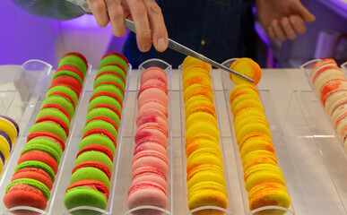 Colorful macarons displayed in a pastry shop with vibrant hues and tempting textures for dessert...