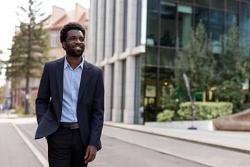 A professional man in formal clothing walking outside a contemporary building, exuding confidence...
