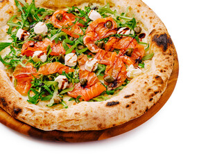 Delicious gourmet pizza topped with salmon and fresh greens on wooden board