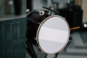 Musical equipment setup with a drum ready for performance in a rehearsal space