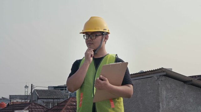 contractors or construction workers are taking notes on a clipboard or checking construction according to work procedures. building and construction concept.	