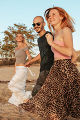 Young people enjoying beach walk at sunset in Potos, Thassos