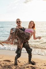 Couple playing in shallow water at golden hour in Potos, Thassos