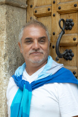 Mature man portrait by rustic wooden door