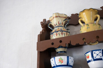 Colorful talavera pottery decorating a kitchen wall shelf