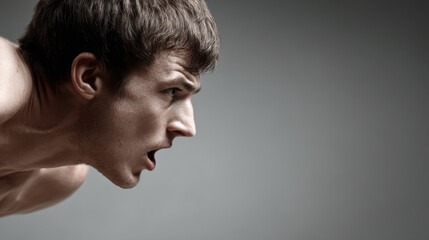 Fototapeta premium young man with open mouth is in sprinter starting pose exuding energy and determination