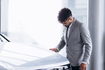 Business man choosing a car in car salon