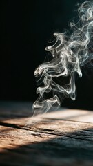 Ethereal wisps of smoke rise gracefully against a dark background, illuminating the wood surface below.