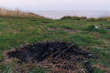 charcoal left over from a burnt-out fire on the ground