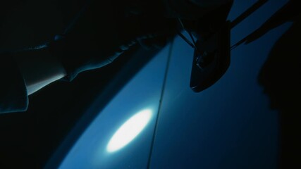 Low angle shot of unrecognizable hands of thief using latchkey to pick door lock before housebreaking