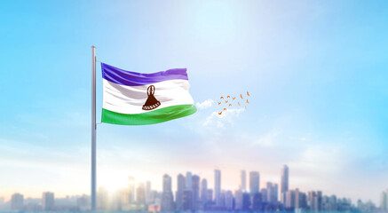 Lesotho national flag waving with skyline and buildings. Lesotho national flag for independence day.