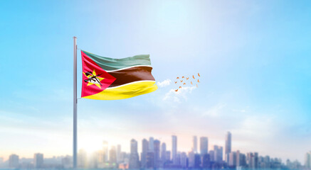Mozambique national flag waving with skyline and buildings. Mozambique national flag for independence day.