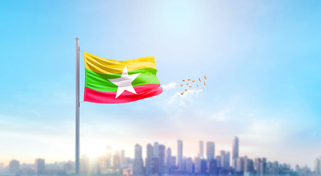 Myanmar national flag waving in the sky.