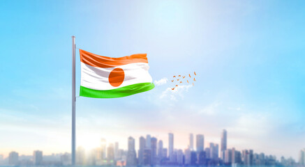 Niger national flag waving with skyline and buildings. Niger national flag for independence day.