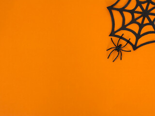 The concept of the Halloween holiday. A spider web on an orange background. Top view, flat surface