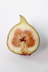 Fresh figs cut in half on a white background