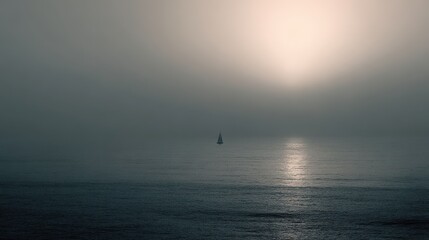Sailing in Sea Fog. A sailboat is sailing, with the sun in the background. Travel