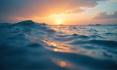 Fototapeta premium Close-up view of dynamic ocean water at sunset, featuring gentle waves and golden light reflections.