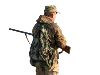 Hunting period, autumn season open. A hunter with a gun in his hands in hunting clothes in the autumn forest in search of a trophy. A man stands with weapons and hunting dogs tracking down the game.