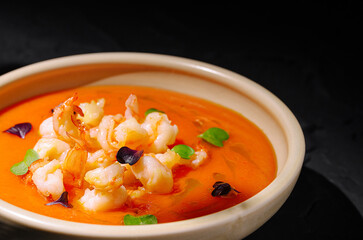 Creamy shrimp soup served in a rustic bowl with vibrant garnishes