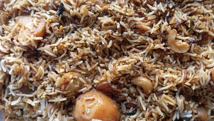 Aloo dum biryani or Potato dum biryanni with potatoes, long grain basmati rice, spices, yougurt, caramelized onions, toasted nuts and herbs. Vegetarian biryani in dum style and royal aroma and flavour