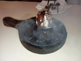 Sizzling brownie with vanilla ice cream topped with chocolate drizzle, served hot on a cast iron...
