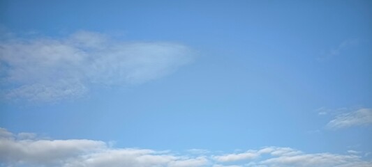 sky is blue and clear with clouds. The sun is shining brightly