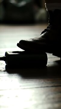 Foot presses power strip switch on floor, activating multiple connected devices with a surge of energy.