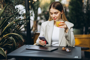 Young woman sitting in a cafe and working on laptop