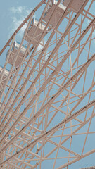 Ferris wheel close up against bright blue sky in sunny summer weather