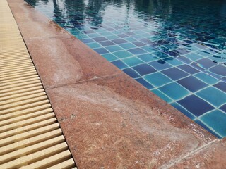 Dried chlorine stains on marble surfaces near the swimming pool.