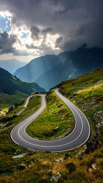 Winding mountain road under dramatic sky