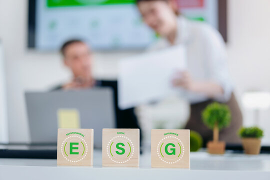 Focus of ESG wooden blocks on a desk represent strategic foundational concepts for business development. professionals, suggesting collaborative planning for future growth and sustainable solution