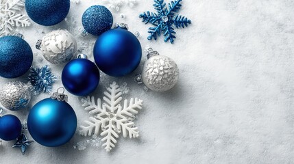 Elegant Christmas Ornament Arrangement with Blue and Silver Baubles on a Textured White Surface