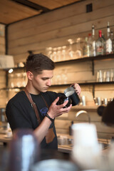 Barista Carefully Pouring Milk Into Coffee in a Modern Cafe Setting