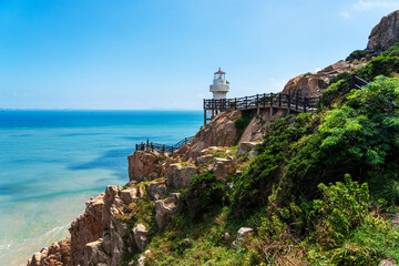 Fototapeta premium Tranquil Coastal Scene Featuring a Majestic Lighthouse by the Sea