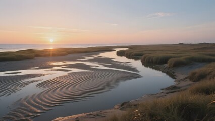 Sunset Over a Tranquil Estuary with Ripples in the Sand