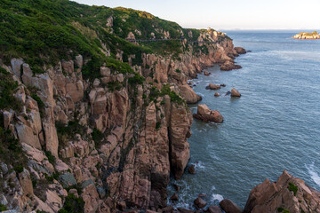 Majestic Coastal Cliffs Overlooking Serene Waters at Sunset