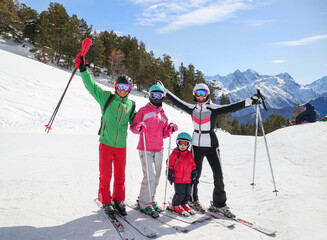 Portrait of a sporting family in equipment at a ski resort