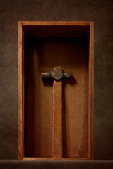 Still life with an old hammer in a wooden box