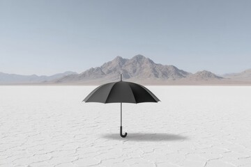 A black umbrella stands alone on white salt flats with distant mountains in the background.