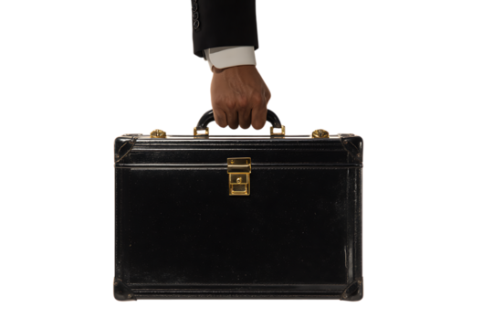Hand holding a briefcase on black background