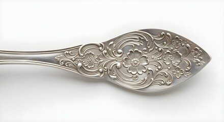Ornate silver spoon handle detail on white background